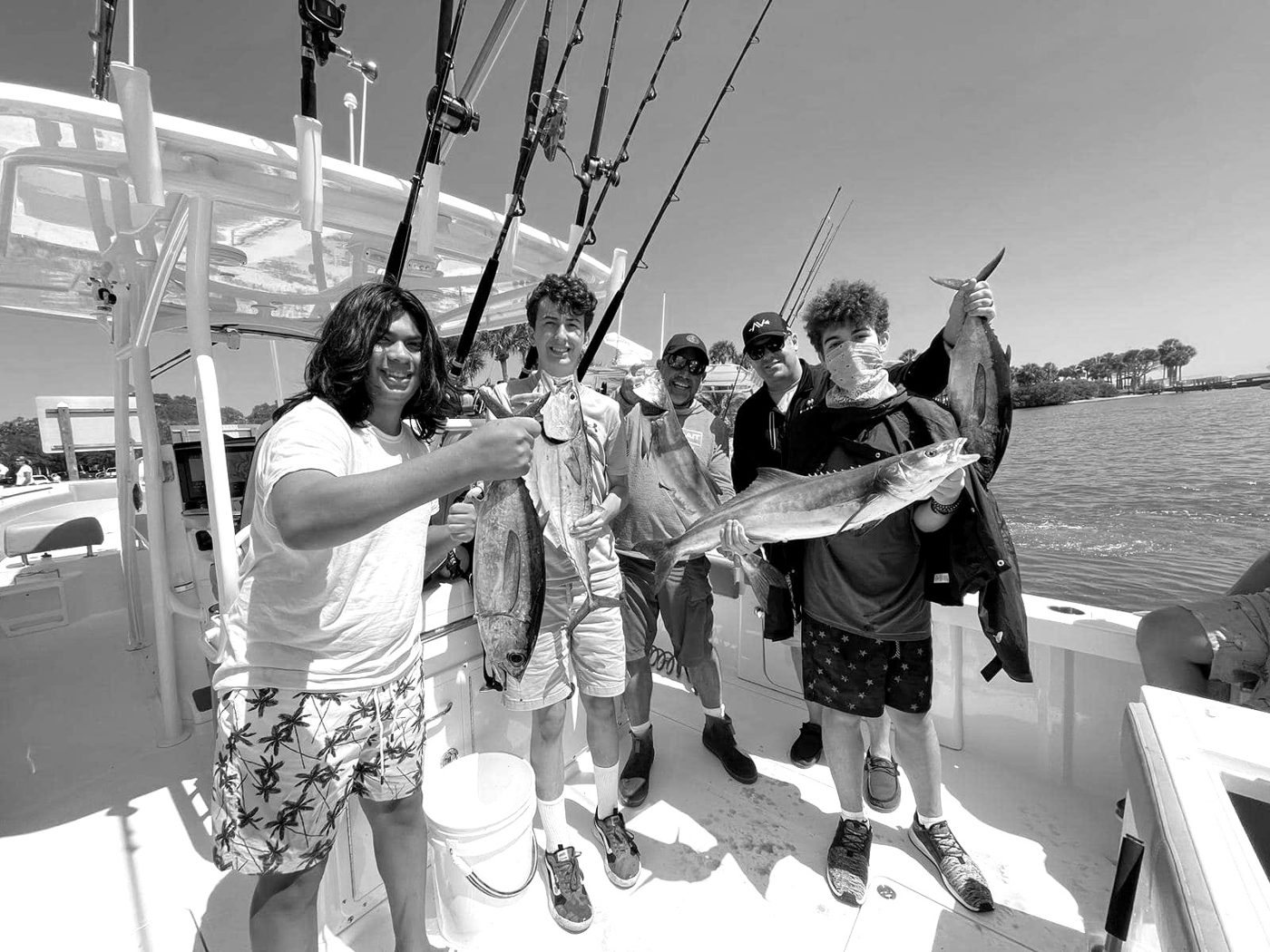 A camper proudly holding up a fish they caught.